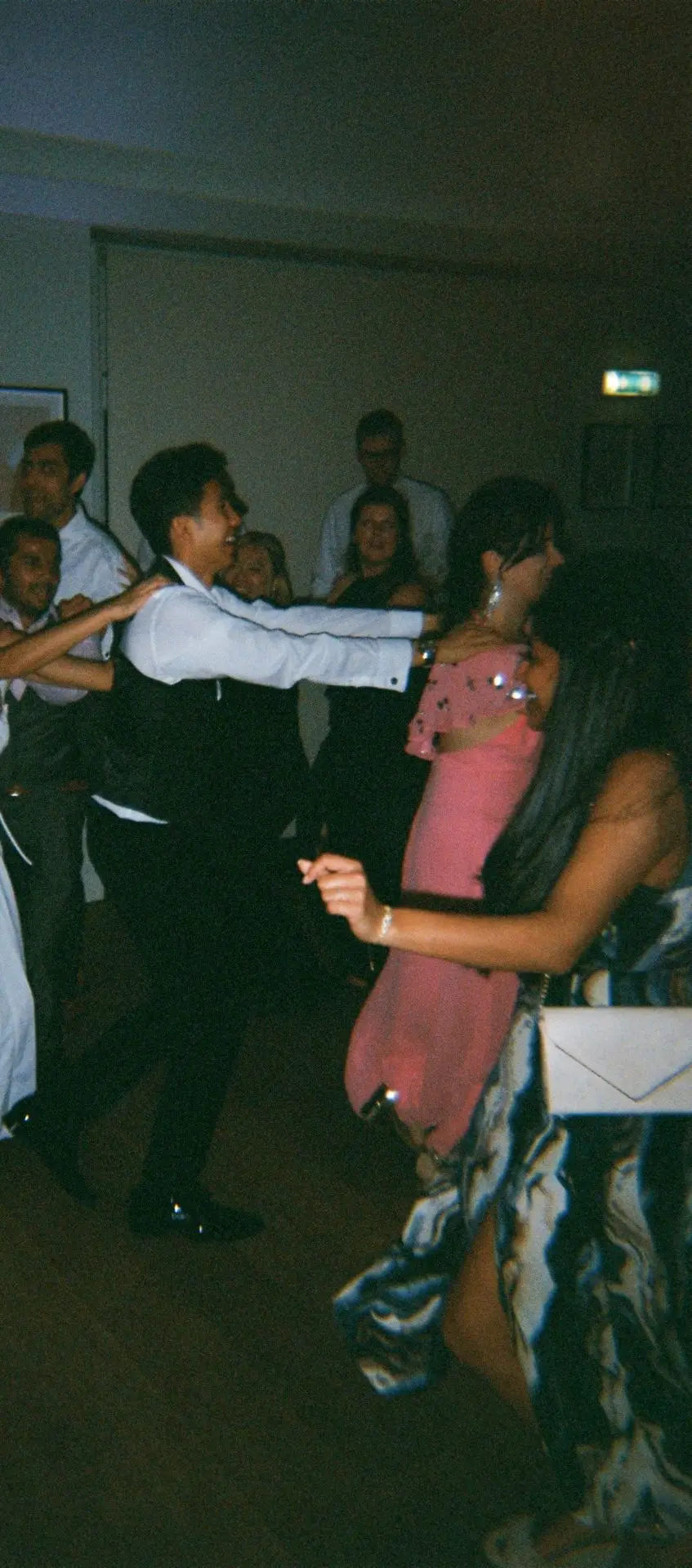 Cropped 35mm film photo of wedding guests dancing